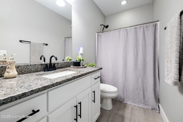 full bathroom with vanity, a shower with shower curtain, and toilet