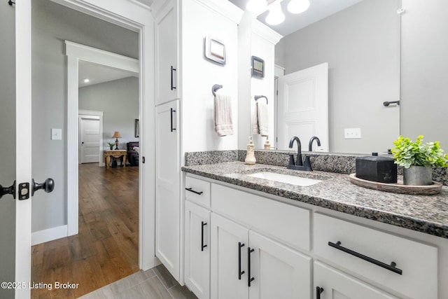bathroom with wood finished floors and vanity