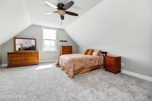 carpeted bedroom featuring vaulted ceiling, baseboards, and ceiling fan