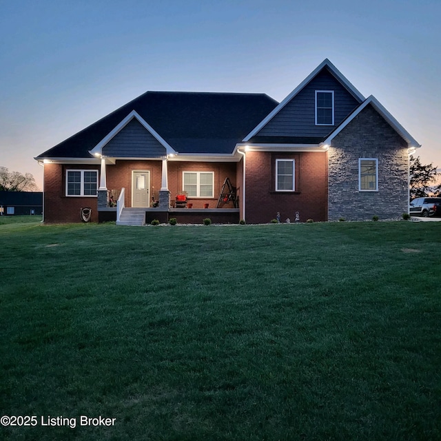 craftsman inspired home with a porch and a front yard