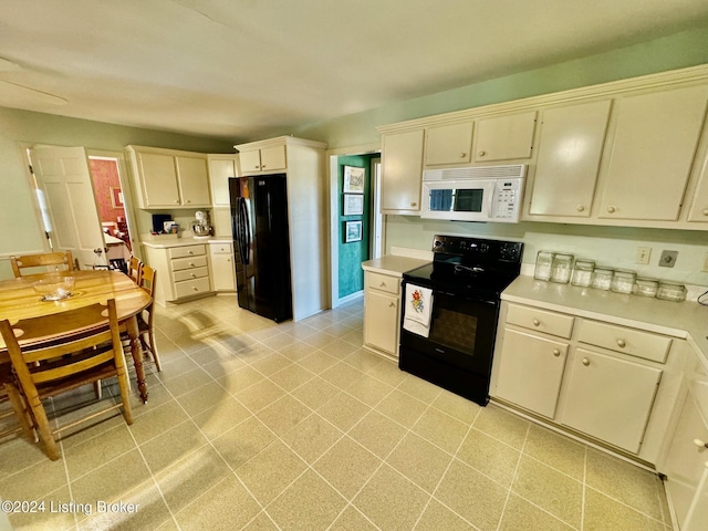 608 Lincoln Park Rd, Springfield, KY 40069 - kitchen featuring light tile patterned floors, light countertops, black appliances, and cream cabinets