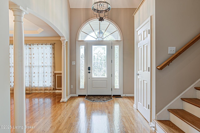 5204 Saratoga View Pl, Louisville, KY 40299 - entrance foyer with arched walkways, wood finished floors, stairway, ornate columns, and ornamental molding