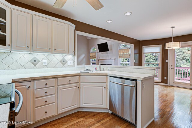 5204 Saratoga View Pl, Louisville, KY 40299 - kitchen featuring dishwasher, light wood-style floors, white cabinets, light countertops, and tasteful backsplash