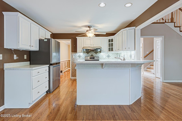 5204 Saratoga View Pl, Louisville, KY 40299 - kitchen featuring under cabinet range hood, freestanding refrigerator, a ceiling fan, light wood-type flooring, and range