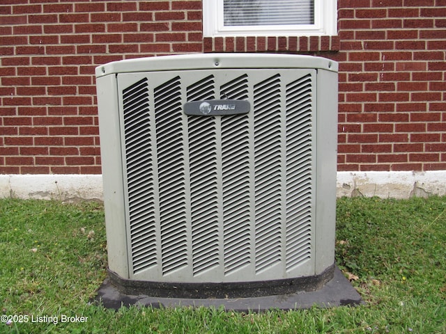 exterior details with cooling unit and brick siding