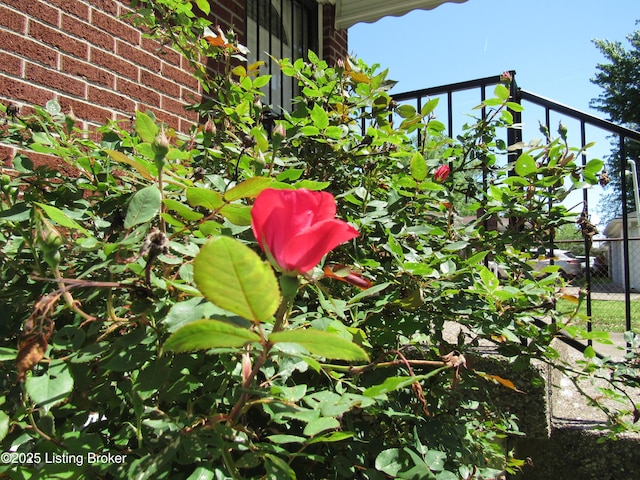exterior details with brick siding and fence