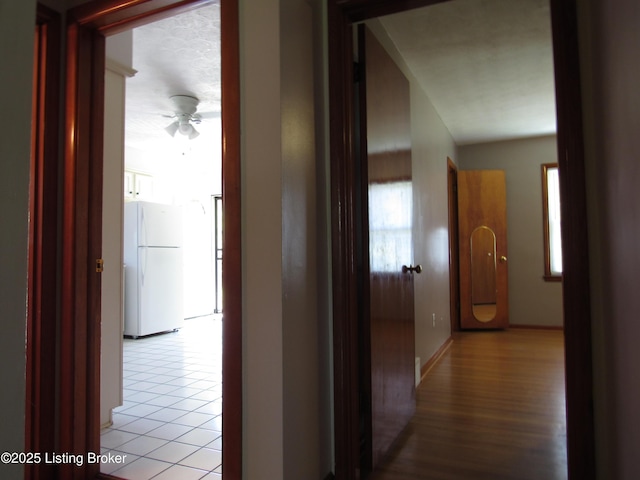 hall featuring light tile patterned floors