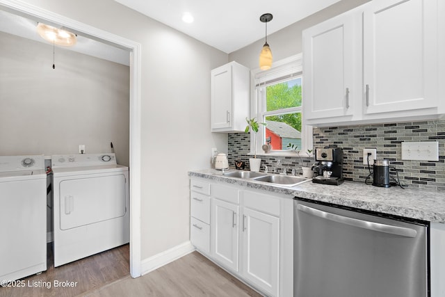 kitchen featuring light wood finished floors, dishwasher, decorative backsplash, separate washer and dryer, and white cabinetry