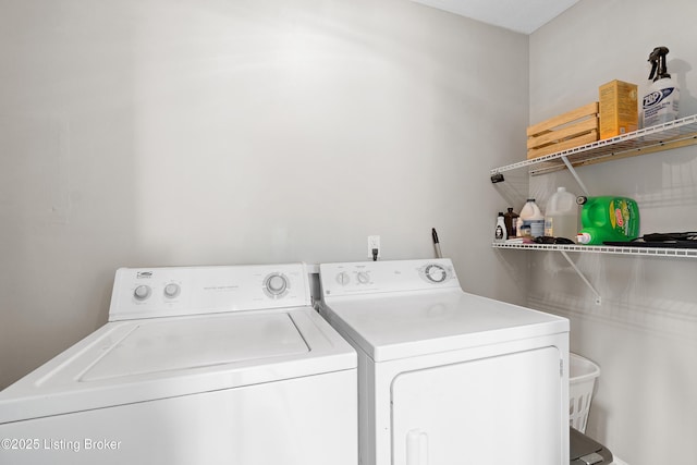 clothes washing area featuring washer and dryer and laundry area