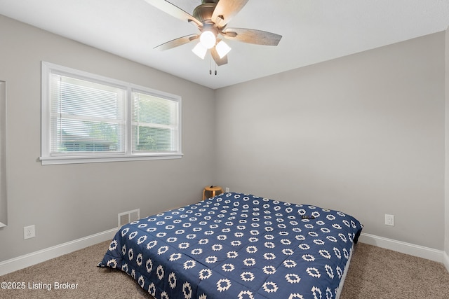 bedroom featuring carpet floors, visible vents, baseboards, and ceiling fan