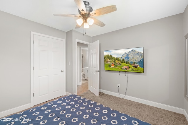 unfurnished bedroom with ceiling fan, carpet floors, and baseboards