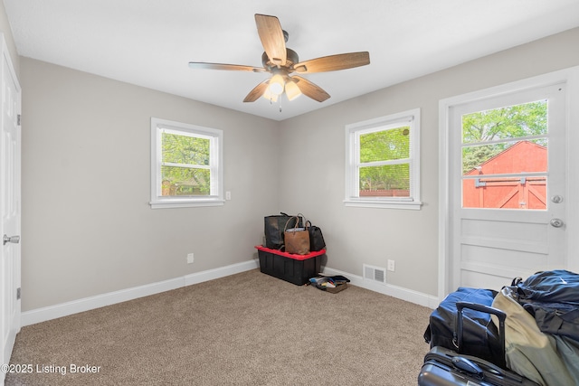 unfurnished bedroom featuring visible vents, carpet flooring, baseboards, and a ceiling fan