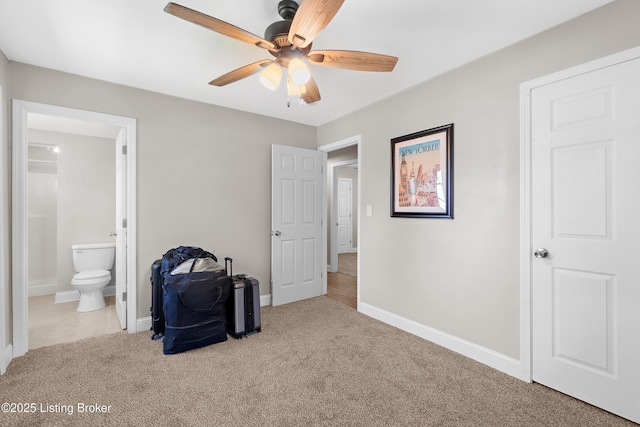 unfurnished bedroom featuring ceiling fan, baseboards, carpet flooring, and ensuite bathroom