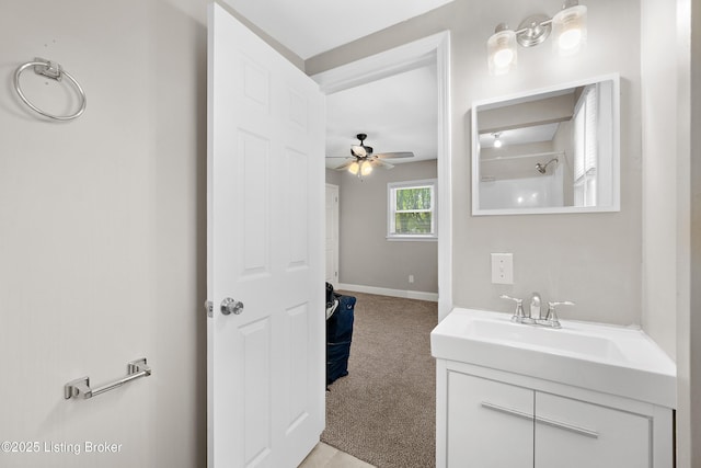 bathroom with baseboards, a ceiling fan, and vanity