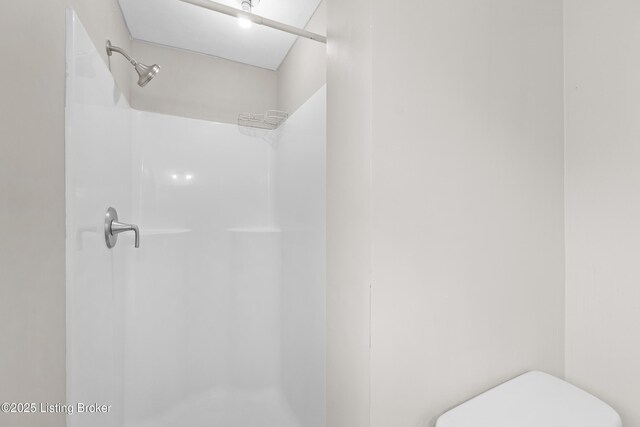 full bathroom with toilet and a shower