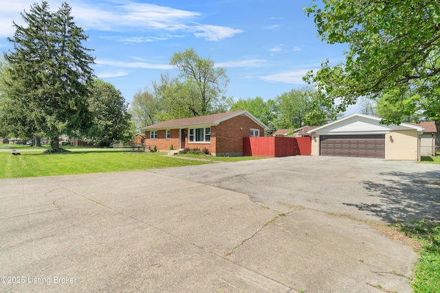 ranch-style home featuring a garage, aphalt driveway, fence, a front yard, and brick siding