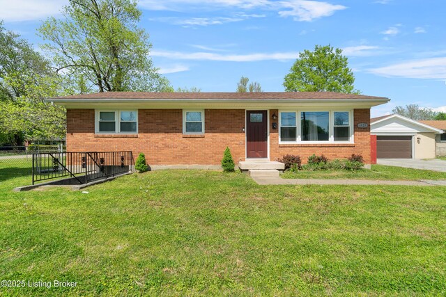 ranch-style home featuring brick siding, a front lawn, and fence
