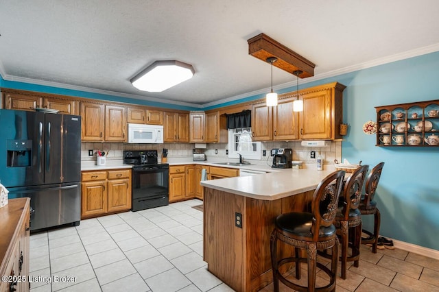kitchen featuring tasteful backsplash, a sink, black appliances, light tile patterned flooring, and a peninsula