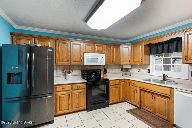kitchen featuring brown cabinets, a sink, and black appliances