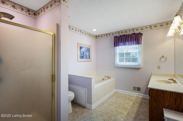 full bathroom featuring baseboards, visible vents, a shower stall, a garden tub, and vanity