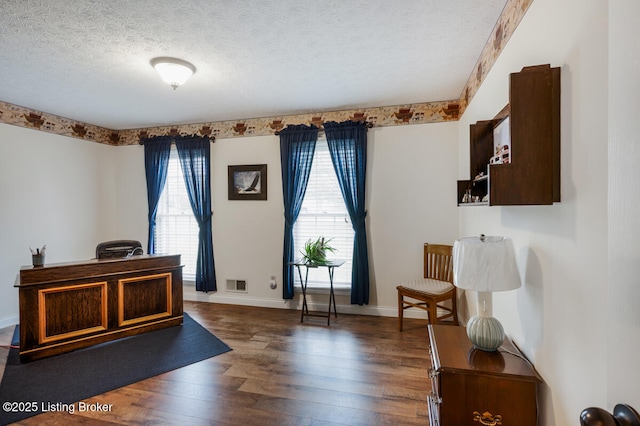 sitting room featuring dark wood finished floors, a textured ceiling, baseboards, and visible vents