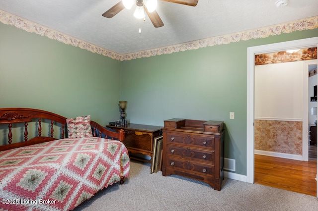 bedroom featuring visible vents, carpet flooring, baseboards, and ceiling fan