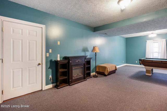recreation room featuring carpet, pool table, baseboards, a textured ceiling, and ceiling fan