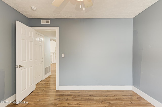 9003 Holly Village Ct, Lyndon, KY 40242 - unfurnished room featuring baseboards, wood finished floors, and visible vents