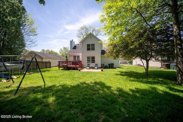 509 Fenley Ave, Lyndon, KY 40222 - back of property featuring fence, a deck, a chimney, a playground, and a yard