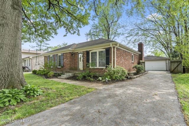 single story home featuring a front lawn, brick siding, an outdoor structure, a detached garage, and a chimney