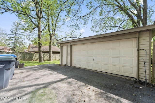 detached garage featuring fence