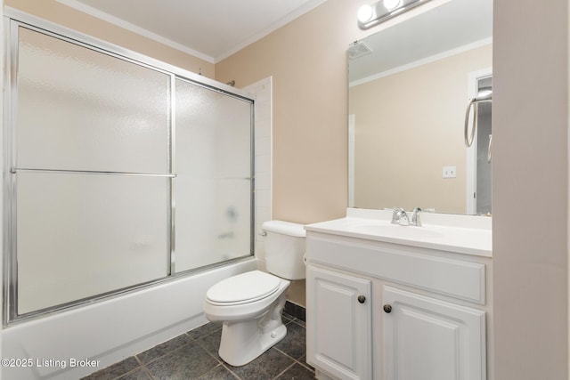 bathroom featuring tile patterned floors, toilet, combined bath / shower with glass door, vanity, and ornamental molding