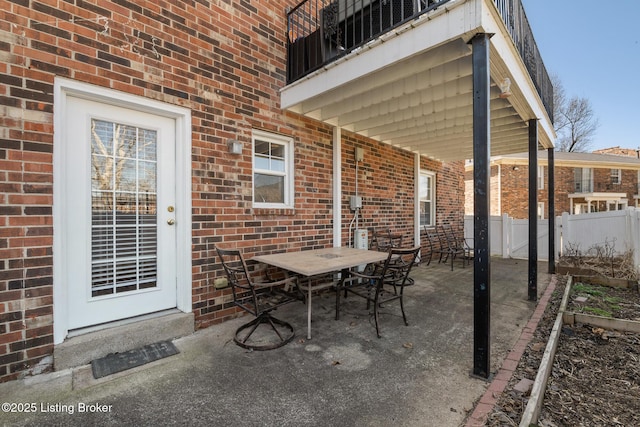 view of patio featuring fence and outdoor dining space