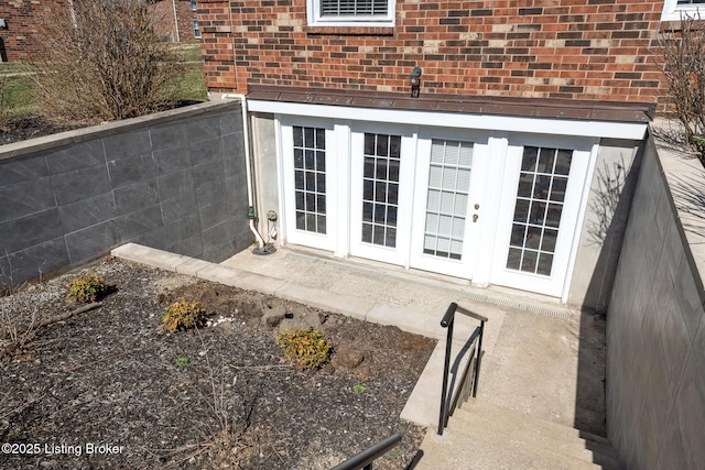 details featuring french doors and brick siding