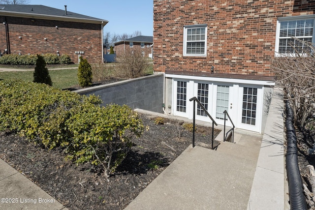 property entrance with french doors and brick siding