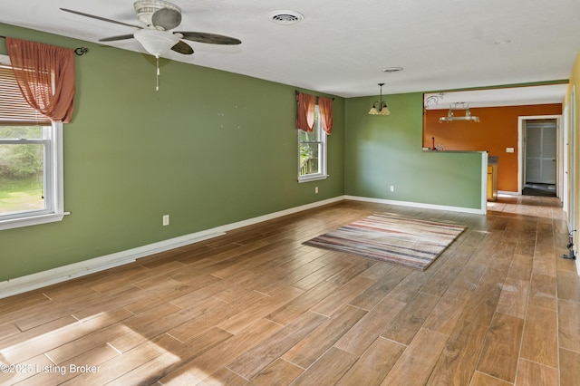 1782 Happy Hollow Rd, Clermont, KY 40110 - unfurnished living room featuring wood finished floors, ceiling fan, and baseboards