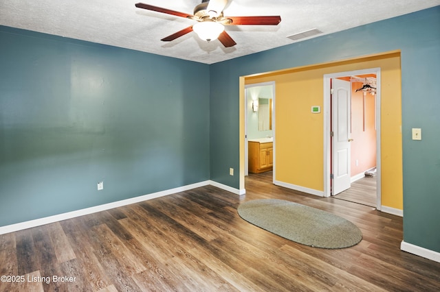 1782 Happy Hollow Rd, Clermont, KY 40110 - unfurnished bedroom with baseboards, wood finished floors, a textured ceiling, ensuite bath, and ceiling fan