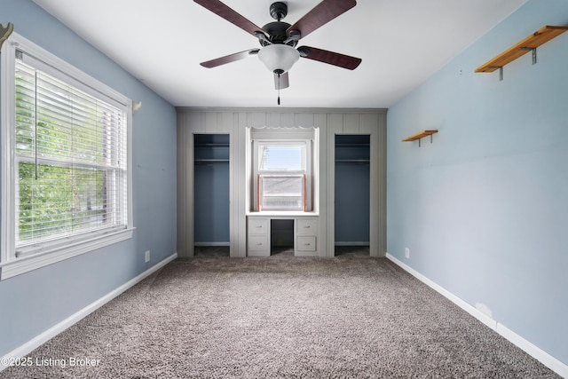 unfurnished bedroom with carpet, a ceiling fan, and baseboards