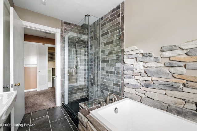 full bath with a stall shower, a bathtub, and tile patterned floors