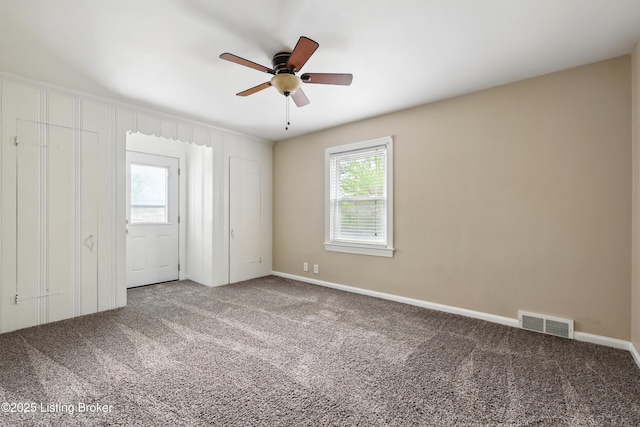 interior space with visible vents, ceiling fan, carpet flooring, and baseboards