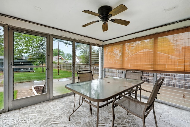 sunroom featuring outdoor dining space and ceiling fan