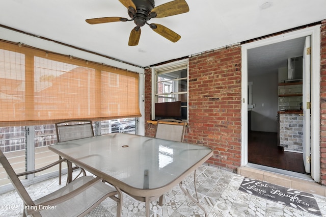 sunroom / solarium featuring ceiling fan and outdoor dining area