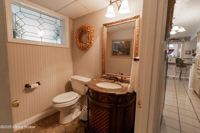 bathroom featuring vanity, toilet, and baseboards