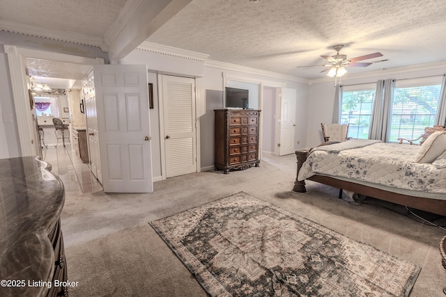 bedroom with ornamental molding, light carpet, baseboards, a ceiling fan, and a textured ceiling