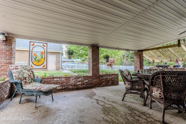 view of patio / terrace featuring fence and outdoor dining space