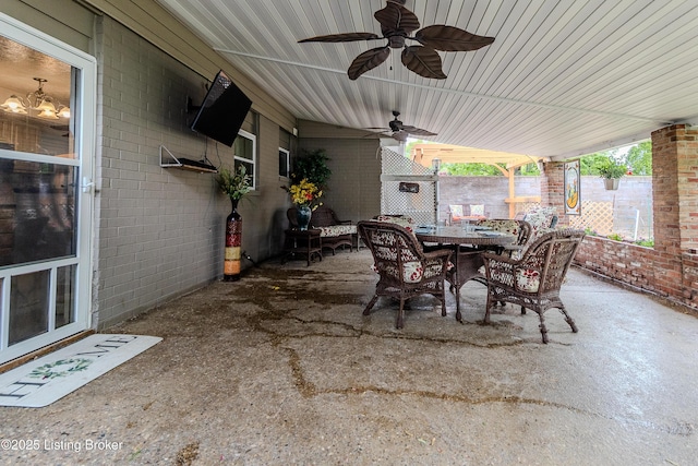 view of patio / terrace featuring fence, outdoor dining space, and ceiling fan