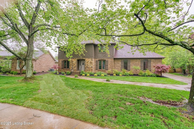 view of front of home with brick siding and a front yard