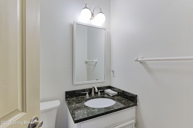 bathroom featuring toilet and vanity