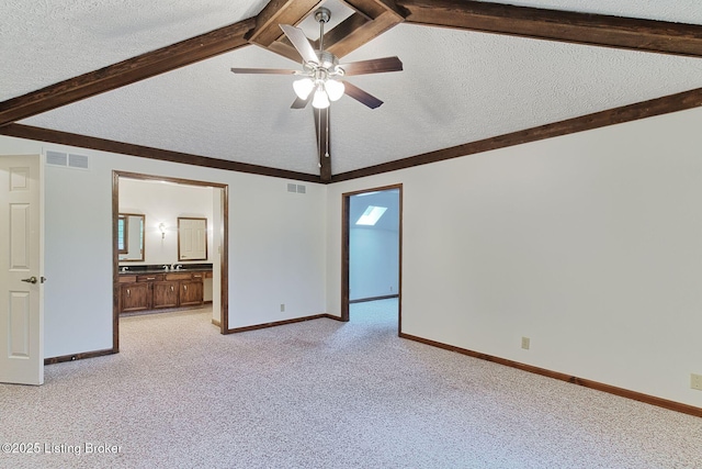 unfurnished room with lofted ceiling with beams, light colored carpet, visible vents, a ceiling fan, and a textured ceiling