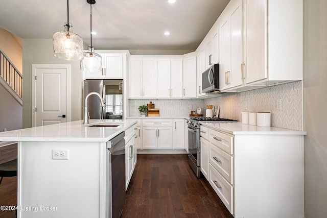 105 Wellston Pl, Louisville, KY 40207 - kitchen featuring a sink, stainless steel appliances, dark wood finished floors, decorative backsplash, and recessed lighting